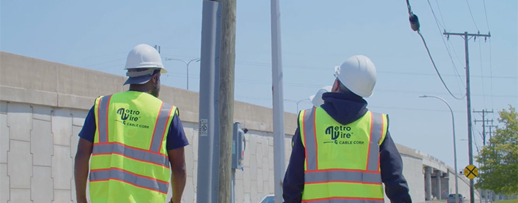 Two Metro Wire Employees Inspecting a Power Line